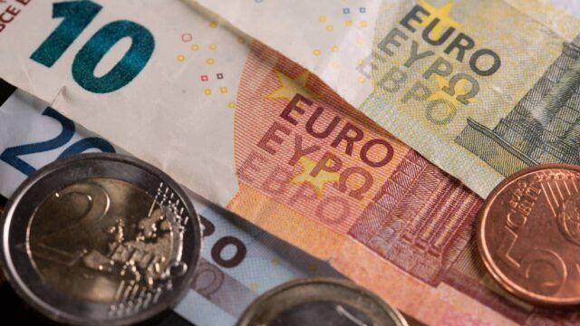 euro cash and heap of coins on the table